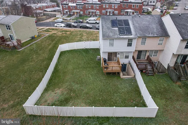 an aerial view of residential houses with outdoor space and swimming pool