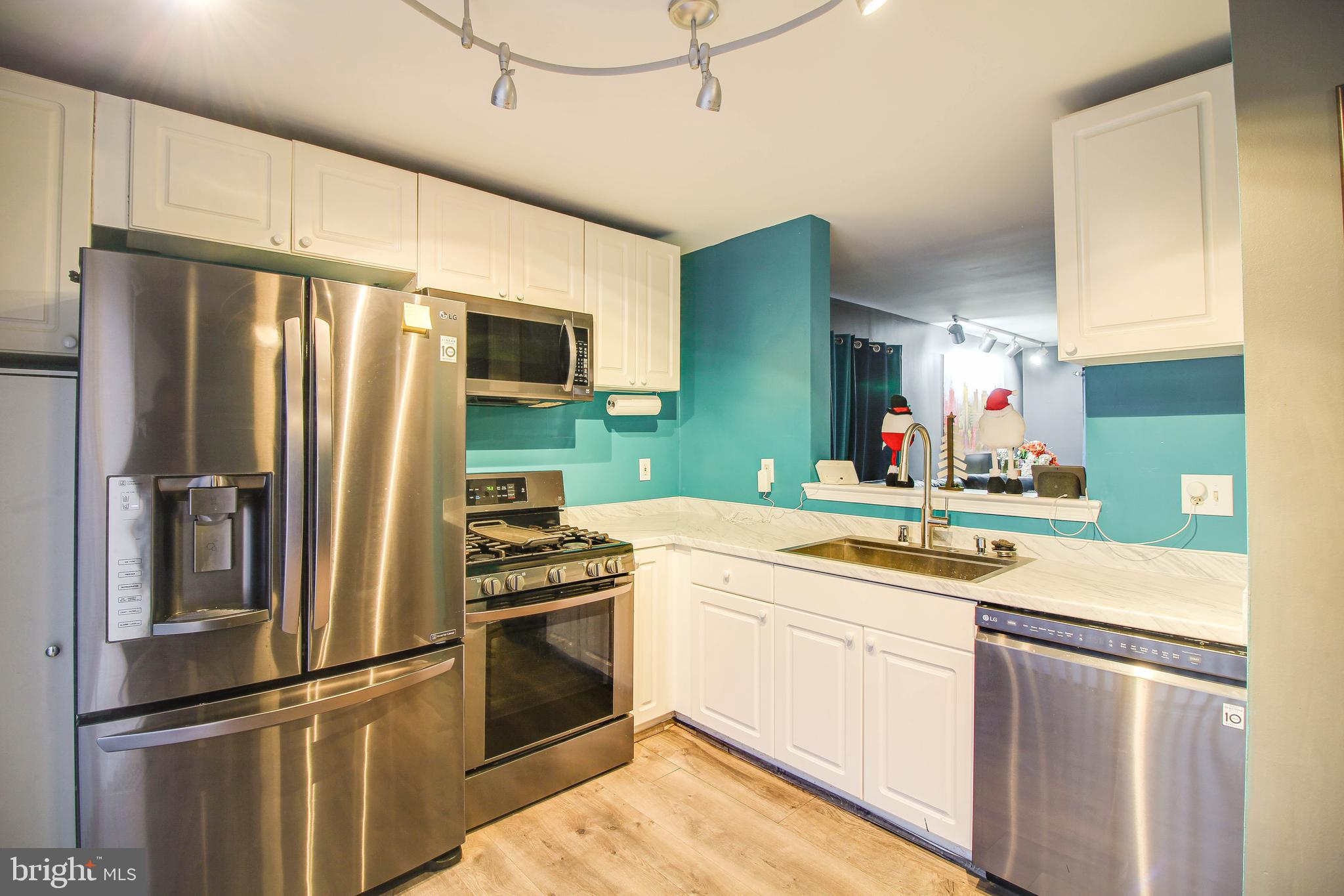 1408 Olmstead Street Curtis Bay, MD 21226 - Photo 6 of 40 a kitchen with stainless steel appliances granite countertop a refrigerator and a sink