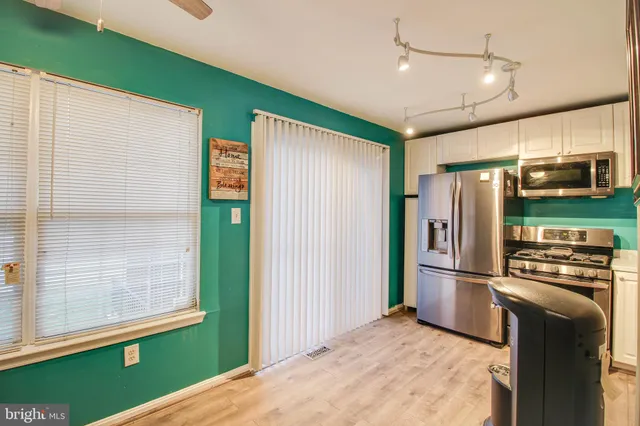 a kitchen with stainless steel appliances granite countertop a refrigerator and a microwave
