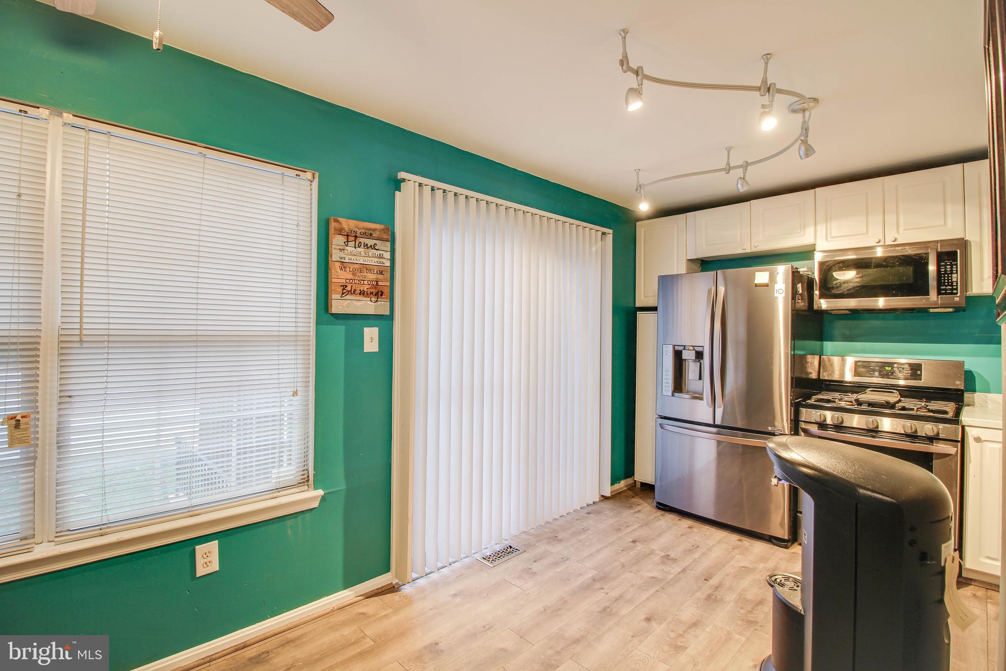 1408 Olmstead Street Curtis Bay, MD 21226 - Photo 7 of 40 a kitchen with stainless steel appliances granite countertop a refrigerator and a microwave