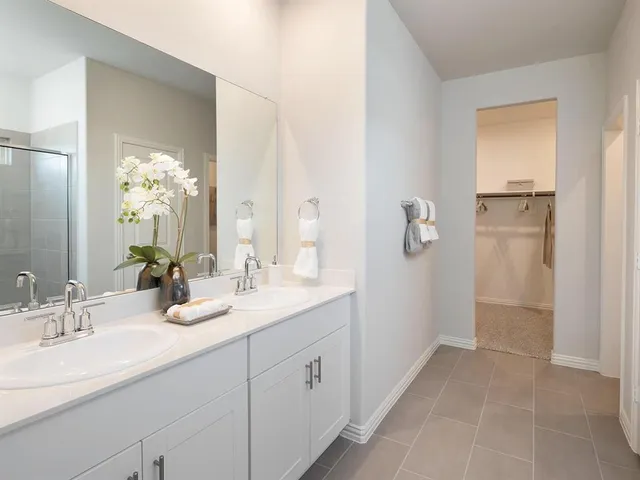 a bathroom with a double vanity sink and mirror