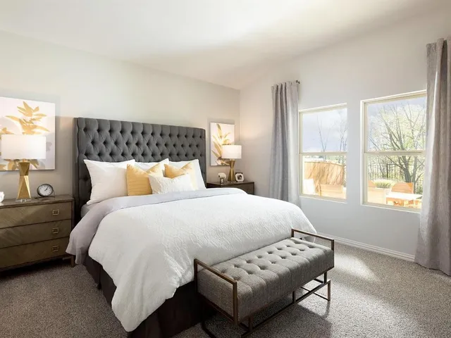 a bedroom with bed and window