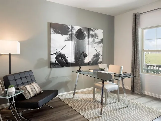 a living room with furniture a window and a table