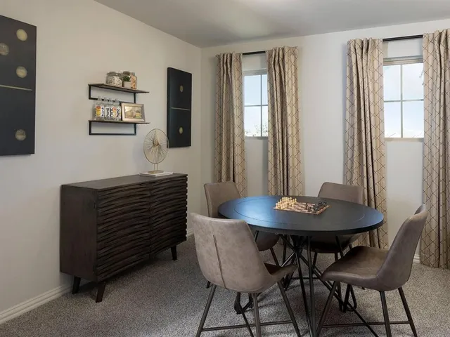 a view of a dining room with furniture and window