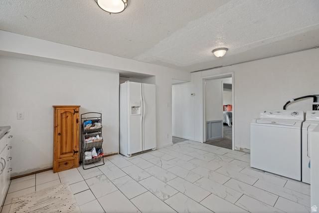 149 West 1600th Street South Mapleton, UT 84664 - Photo 32 of 44 Laundry area with a textured ceiling, separate washer and dryer, and light marble finish flooring