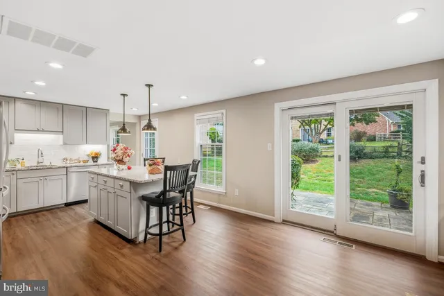 a kitchen with a table chairs sink and cabinets