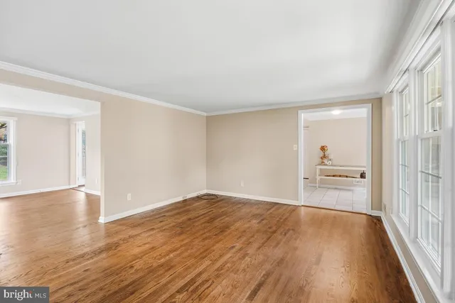 a view of a room with wooden floor and a window