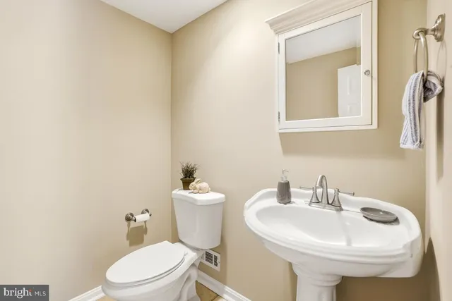 a white toilet sitting next to a bathroom sink