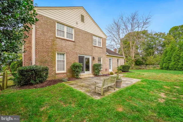 a view of a house with a yard and sitting area