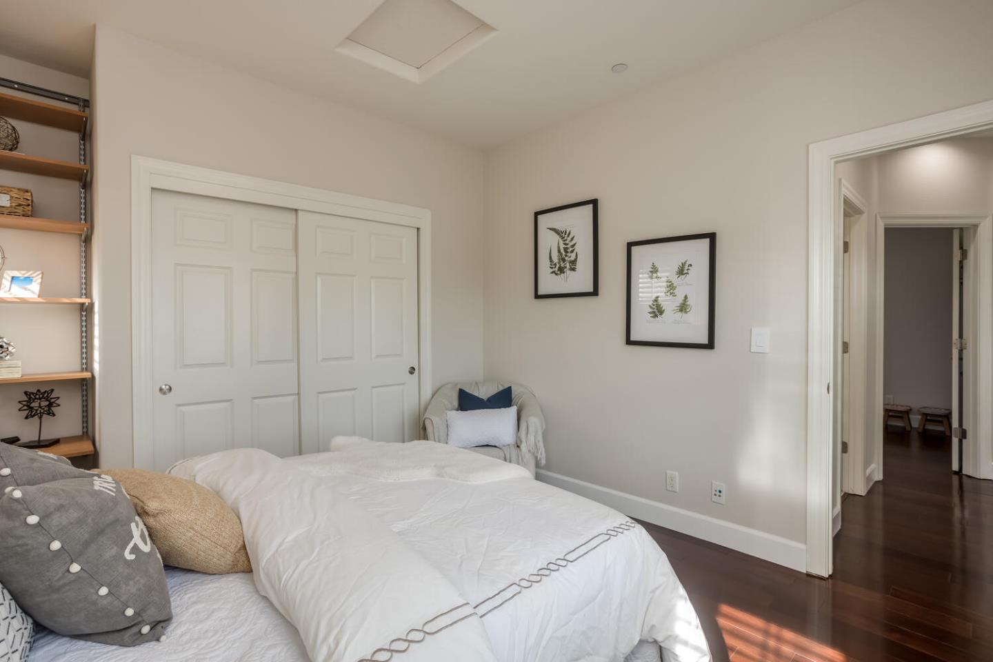 563 Alberta Avenue Sunnyvale, CA 94087 - Photo 24 of 32 a bedroom with a large bed and wooden floor
