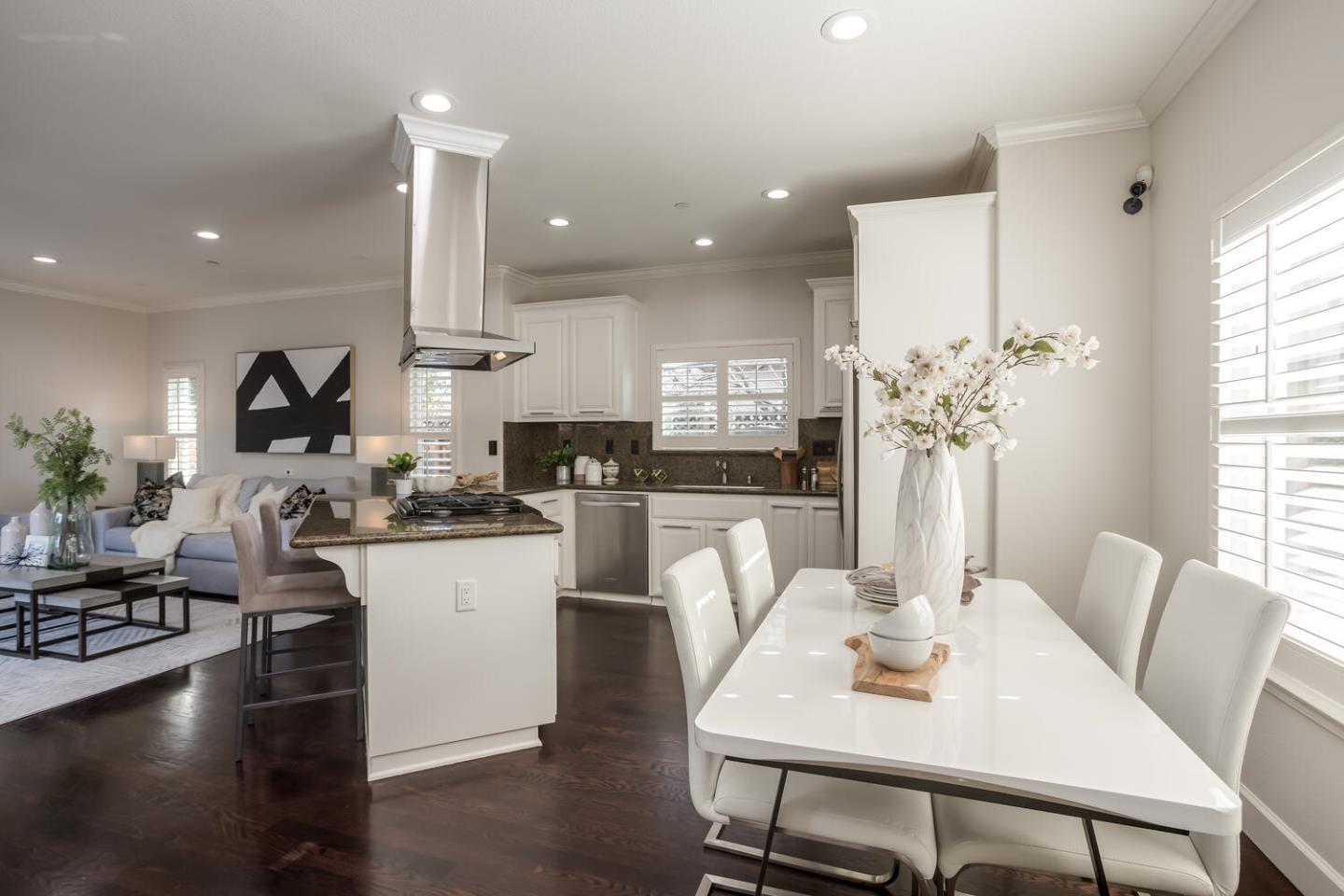 563 Alberta Avenue Sunnyvale, CA 94087 - Photo 10 of 32 a kitchen with stainless steel appliances kitchen island granite countertop a stove a sink a dining table and chairs
