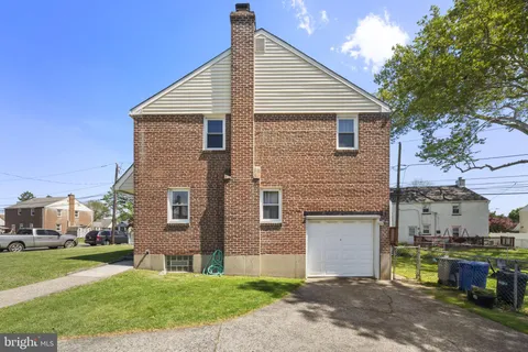 a front view of a house with a garden and yard