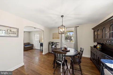 a view of a dining room with furniture wooden floor and chandelier