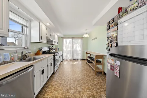a kitchen with granite countertop lots of counter top space and stainless steel appliances