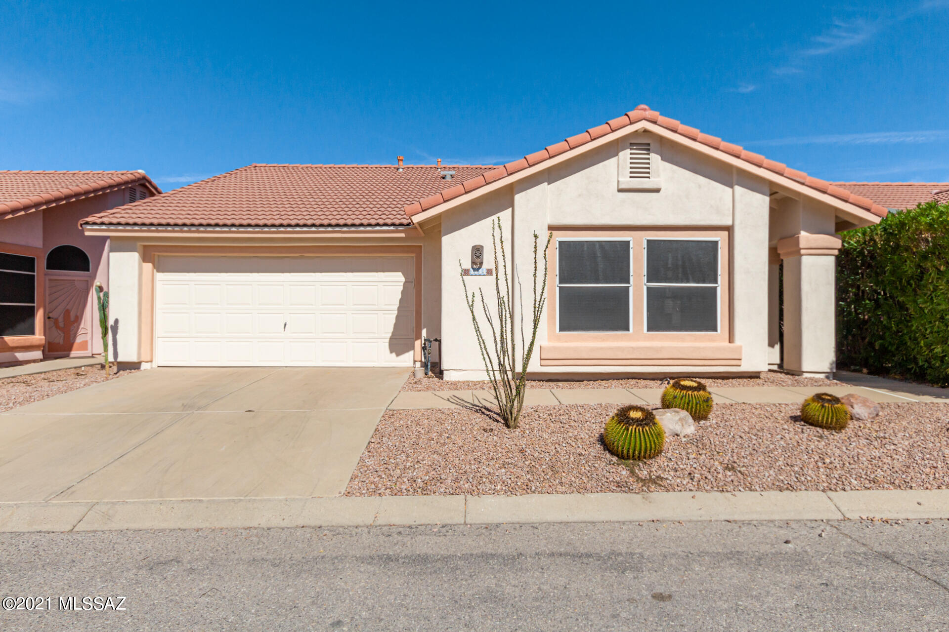 3034 West Sky Ranch Trail Tucson, AZ 85742 - Photo 1 of 27 a front view of a house with a yard