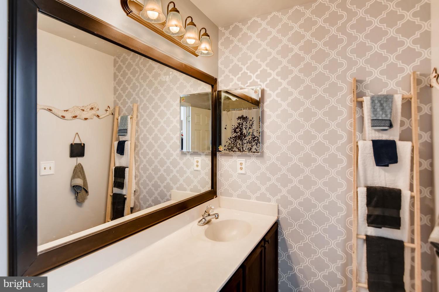 4517 Sandwood Road Baltimore, MD 21219 - Photo 14 of 27 a bathroom with a sink and a mirror