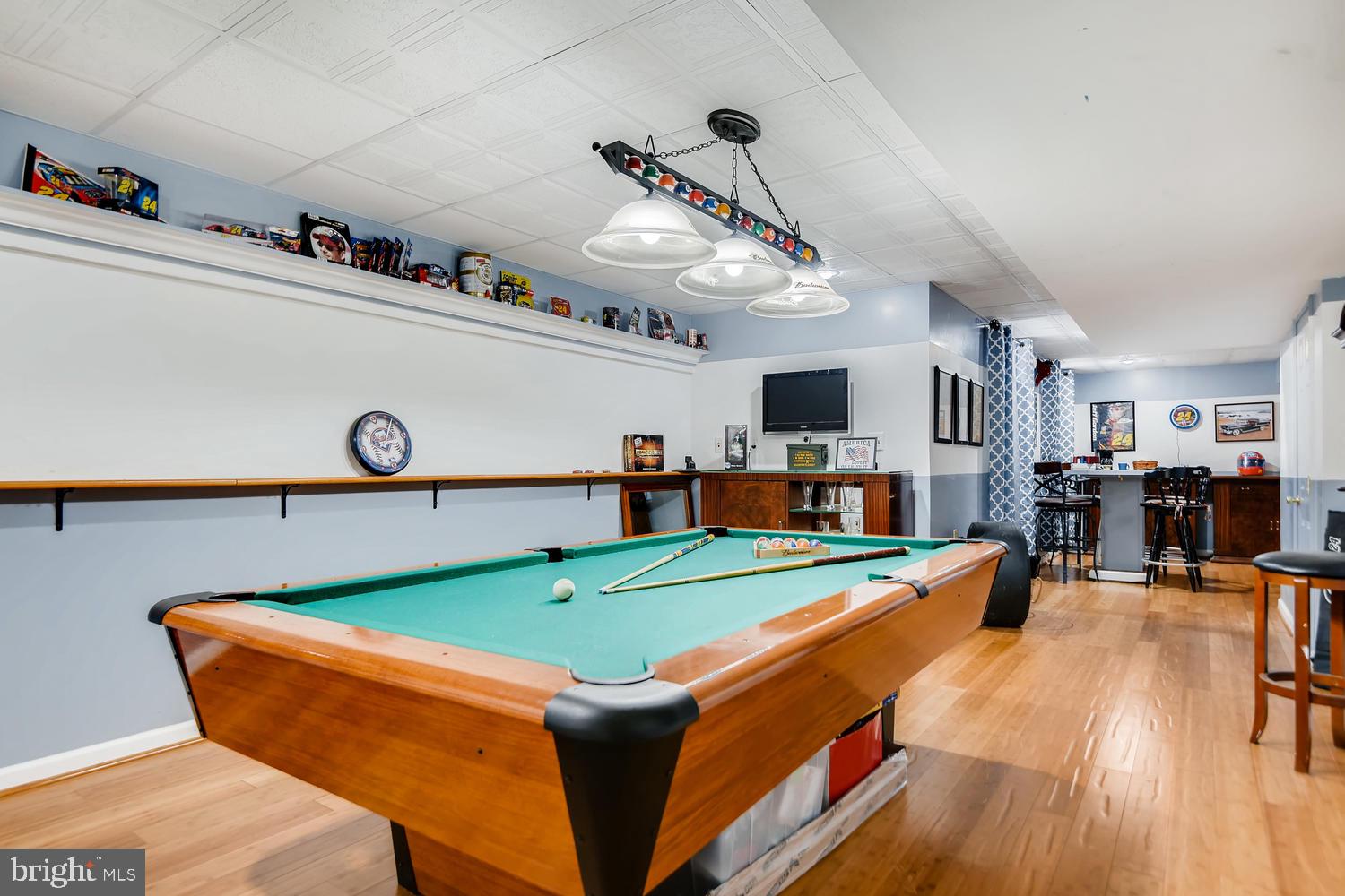 4517 Sandwood Road Baltimore, MD 21219 - Photo 22 of 27 a room with table chairs and a flat screen tv