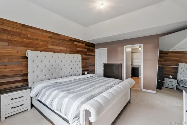a large bed sitting in a bedroom and a table