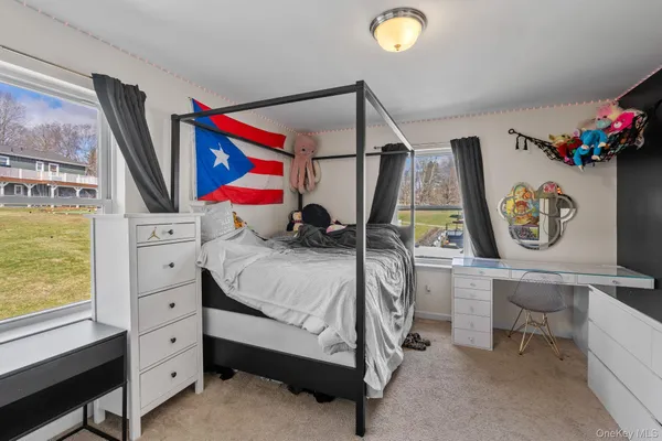 a bedroom with a bed and a bookshelf