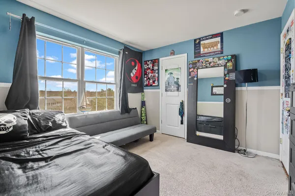 a bedroom with a bed and a couch