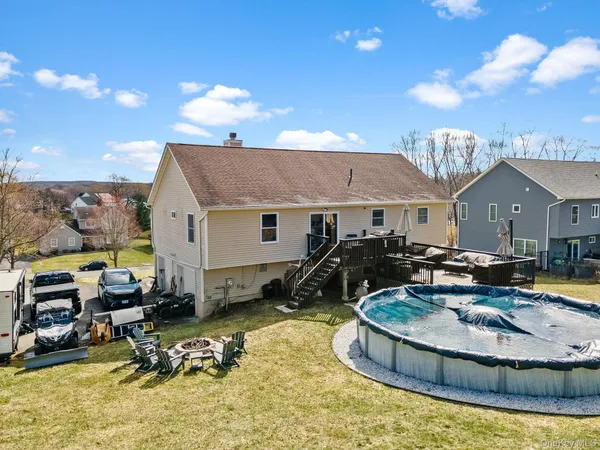 a view of a house with a yard and sitting area