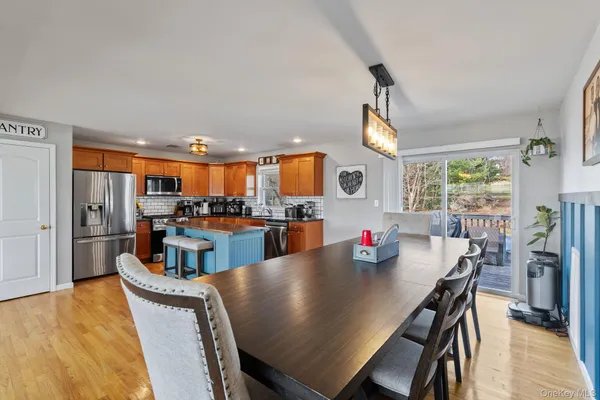 a view of a dining room with furniture and a floor to ceiling window