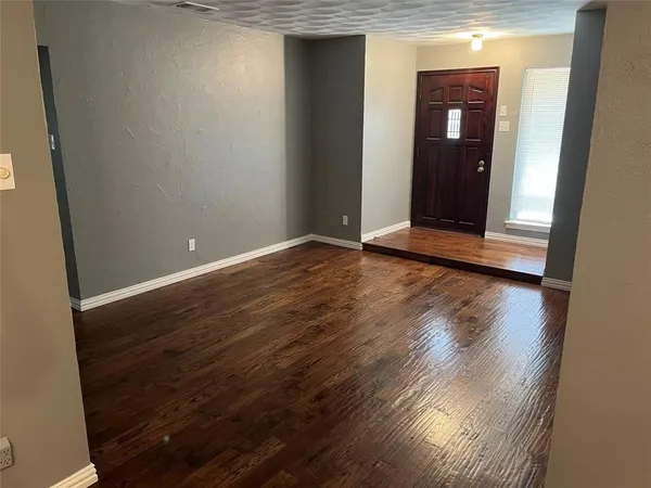 an empty room with wooden floor and closet