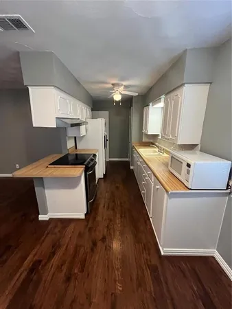 a kitchen with stainless steel appliances a stove a sink dishwasher and a refrigerator