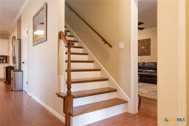 a view of entryway and hall with wooden floor