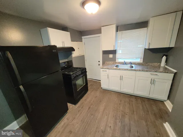a kitchen with stainless steel appliances a refrigerator sink and cabinets