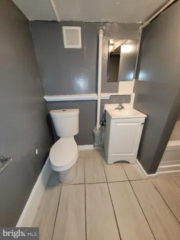 a white toilet sitting next to a bathroom sink