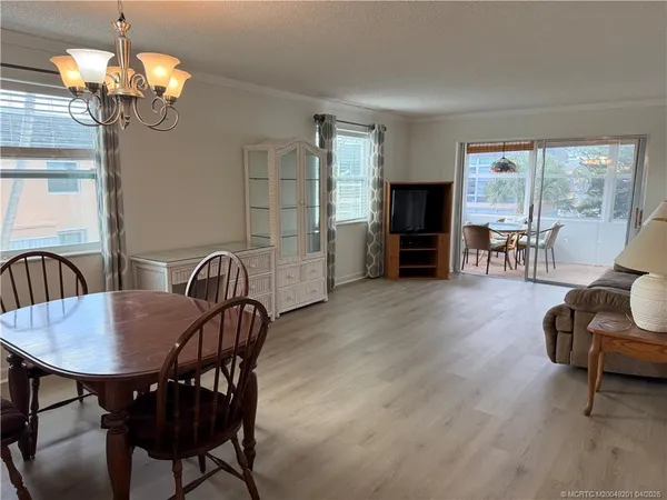 a view of a dining room with furniture wooden floor and chandelier