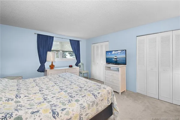 a bedroom with a bed and a cabinets