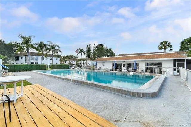 a view of house with swimming pool and seating