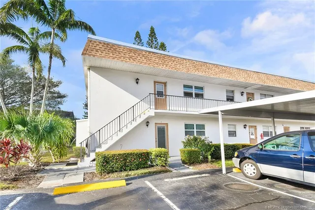a front view of a house with a garden and plants