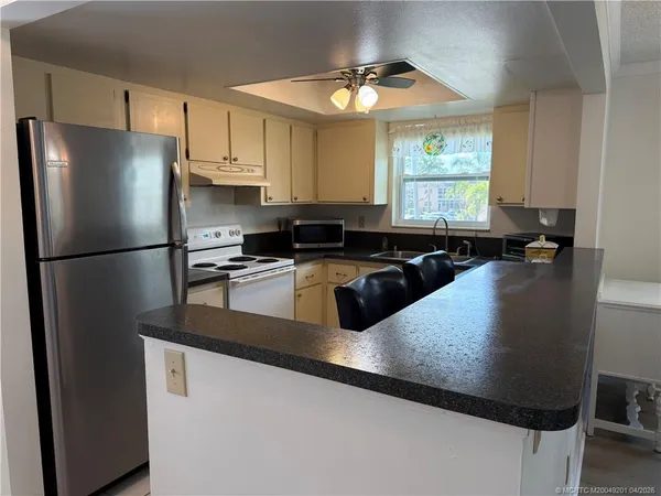 a kitchen with a refrigerator and a sink