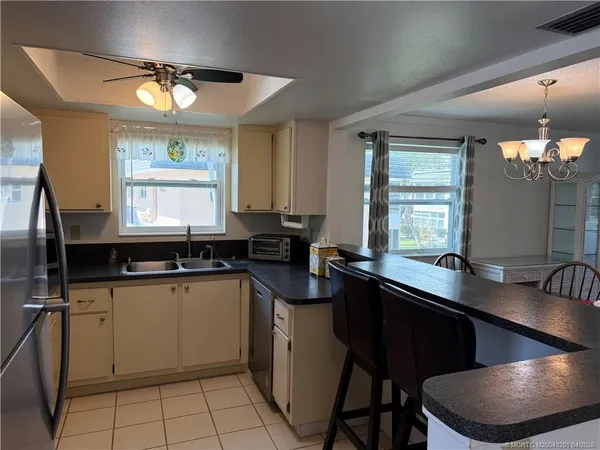 a kitchen with a table chairs sink and cabinets