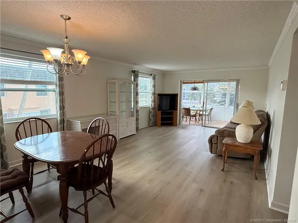 a view of a dining room with furniture wooden floor and chandelier
