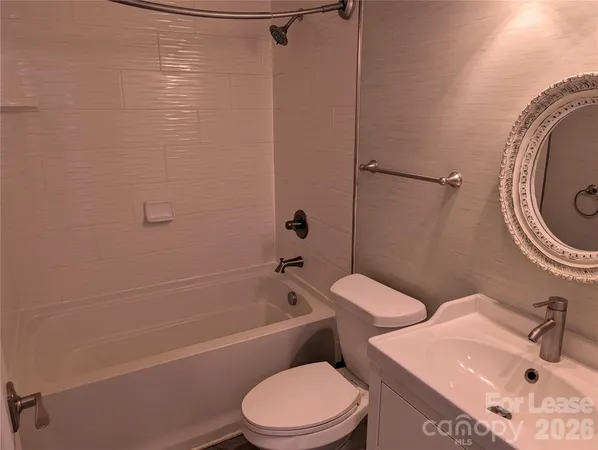 a view of a room with a hardwood and a bathroom