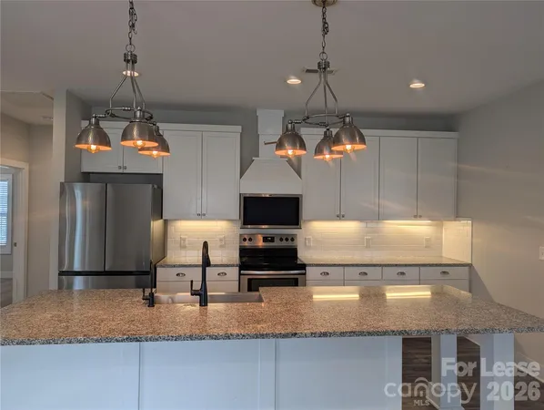 a kitchen with a refrigerator a sink and a stove