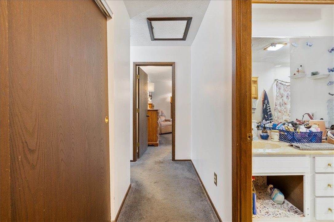 7225 Garber Road Clayton, OH 45415 - Photo 11 of 33 This interior hallway features carpet flooring and leads to various rooms within the home.