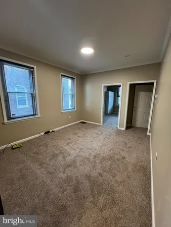 an empty room with windows and closet