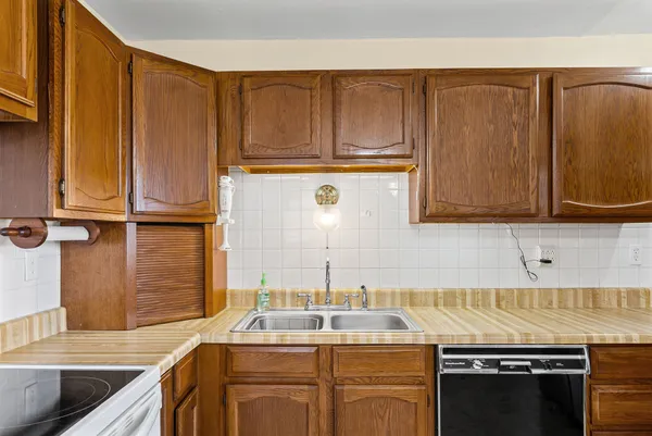 a kitchen with stainless steel appliances granite countertop a sink stove and cabinets
