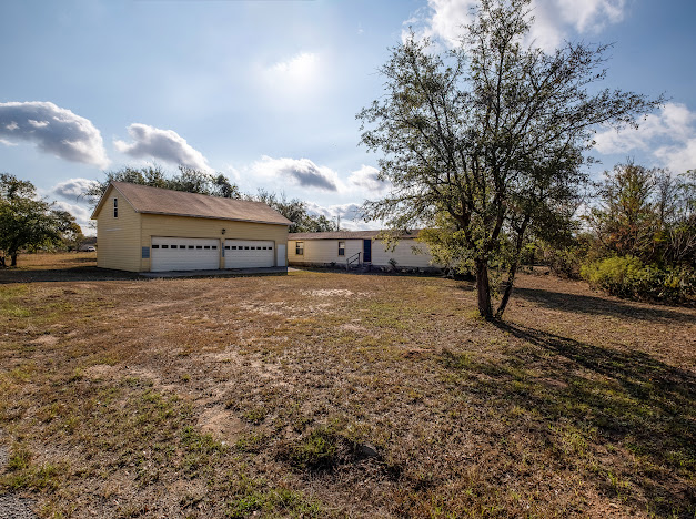 a view of a field with some trees in the background