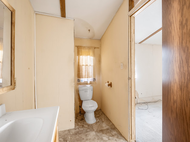 119 East Clearview Cemetery Road Bastrop, TX 78602 - Photo 19 of 22 a bathroom with a granite countertop sink a toilet and shower