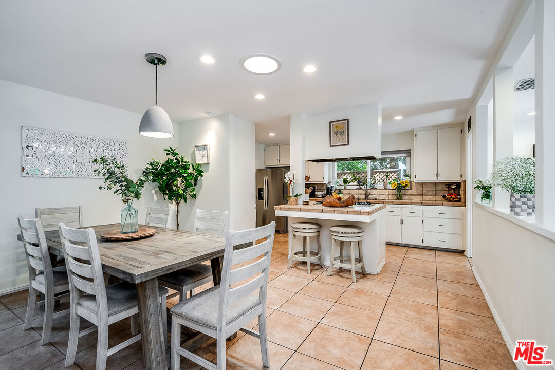 18924 Cantara Street Reseda, CA 91335 - Photo 11 of 31 a kitchen with a table and chairs in it