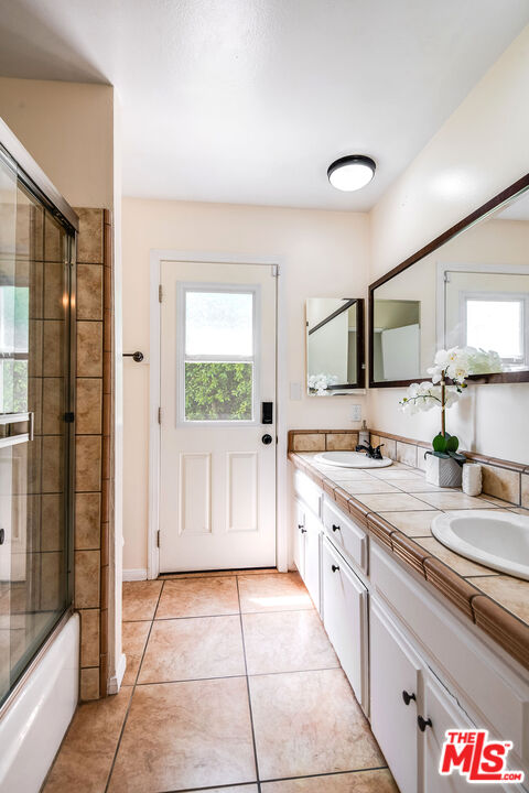 18924 Cantara Street Reseda, CA 91335 - Photo 14 of 31 a spacious bathroom with a granite countertop sink a mirror and a shower