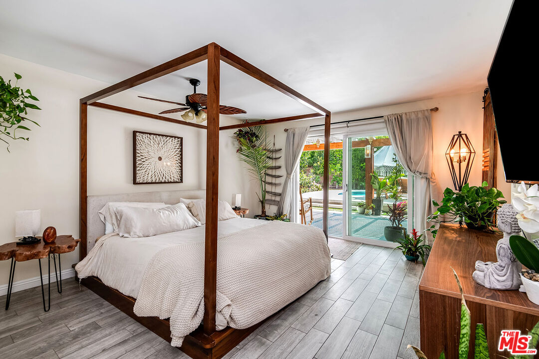 18924 Cantara Street Reseda, CA 91335 - Photo 16 of 31 a bedroom with a large bed and a flat tv screen on dresser