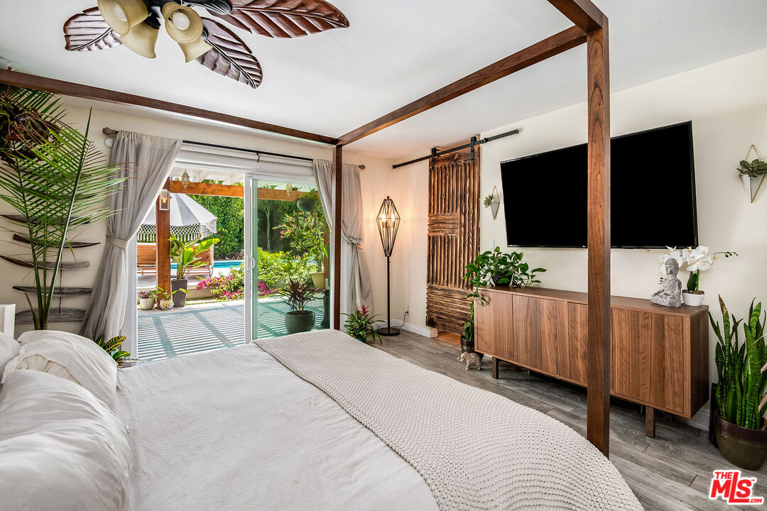 18924 Cantara Street Reseda, CA 91335 - Photo 17 of 31 a bed room with a bed television and a large window