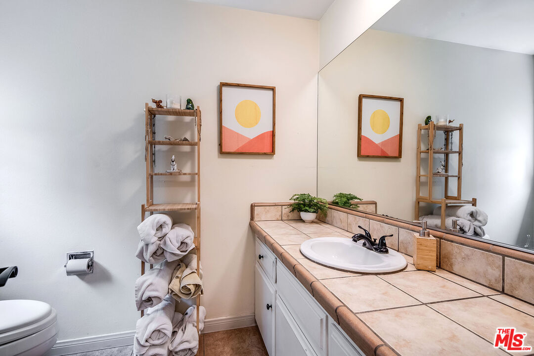 18924 Cantara Street Reseda, CA 91335 - Photo 18 of 31 a bathroom with a sink and a mirror